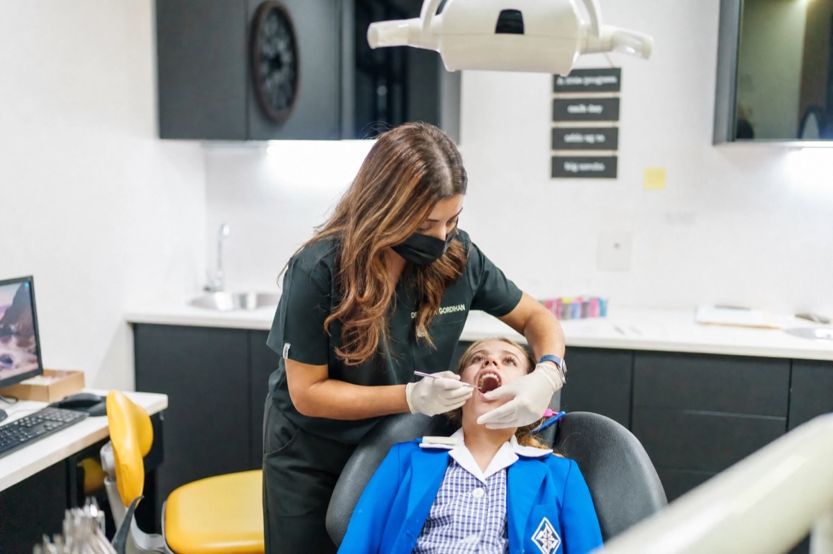 Dentist gently examining a child’s teeth